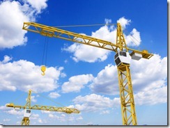 Construction cranes on sky background Construction cranes on sky background
